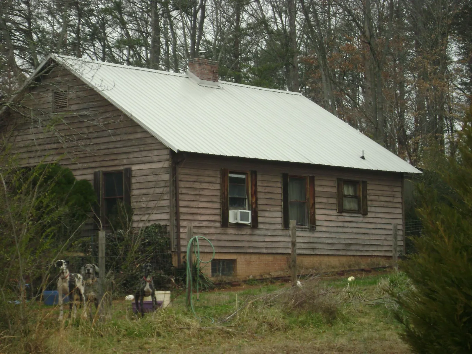 White metal roof on an old wood sided farmhouse, from a Metal Roof Installation job in Dwight